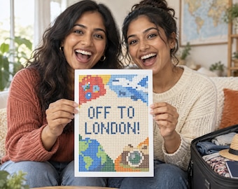 May include: A rectangular diamond painting craft project featuring the text OFF TO LONDON! in dark blue block letters. The design includes colorful pixelated icons of a red double-decker bus, a blue airplane, a green and blue globe, and a camera.