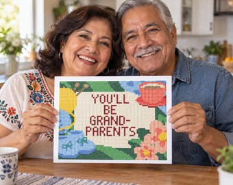 May include: A rectangular sign featuring a pixelated cross-stitch design with the text YOU'LL BE GRANDPARENTS in dark red letters. The artwork includes a yellow ball of yarn, blue baby booties, a red coffee cup, and pink flowers on a green background.
