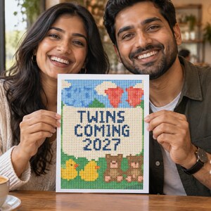 May include: A rectangular sign featuring a pixelated design with the text TWINS COMING 2027 in dark blue. The design includes blue clouds, red hearts, two yellow ducks, and two brown teddy bears on a green background, all rendered in a grid pattern.
