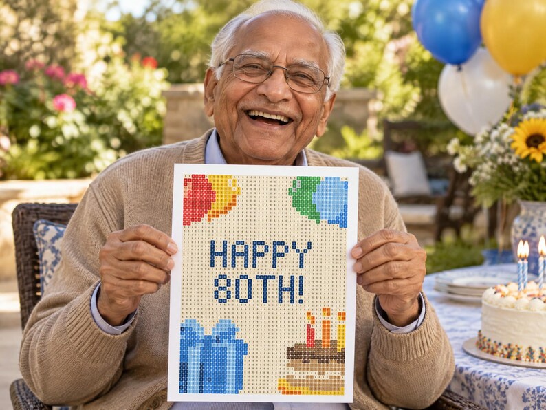 May include: A rectangular diamond painting craft project featuring a pixelated design with the text HAPPY 80TH! in dark blue. The artwork includes colorful balloon clusters, a blue gift box with a bow, and a birthday cake with three lit candles.