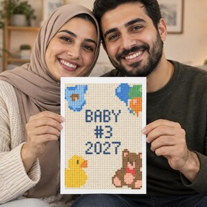 May include: A rectangular white sign featuring a pixelated design with the text BABY #3 2027 in dark blue. The design includes a blue baby onesie, a cluster of blue, green, and orange balloons, a yellow rubber duck, and a brown teddy bear.