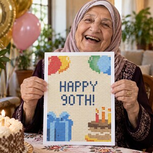 May include: A rectangular craft project featuring a pixelated design on a light background. The text reads HAPPY 90TH! in dark blue. The image includes a red and yellow balloon, green and blue balloons, a blue gift box, and a birthday cake with candles.