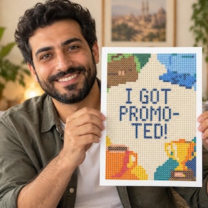 May include: A rectangular print featuring a pixel art design with the text I GOT PROMOTED! in dark blue. The artwork includes a golden trophy, a brown coffee mug, and abstract blue and brown shapes against a light cream background.
