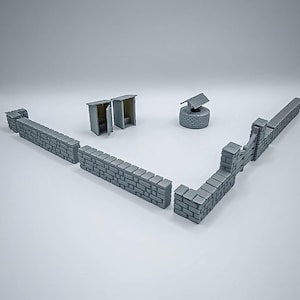 Könnte beinhalten: Eine Miniatur-Grauziegelmauer, zwei Toilettenhäuschen und ein Brunnen sind auf einer weißen Oberfläche angeordnet. Der Brunnen hat ein kleines Dach und eine kreisförmige Basis. Die Toilettenhäuschen haben offene Türen. Die Mauer besteht aus einzelnen Ziegeln.