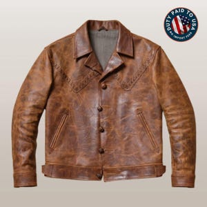 May include: A brown leather jacket with a distressed finish, featuring a pointed collar, four front buttons, two slanted welt pockets, and decorative stitching across the chest. The interior lining is grey, and a circular badge displays the American flag.