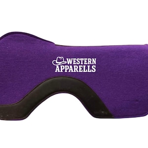 May include: A purple Western saddle pad with a black leather accent along the bottom edge. The pad features the text "WESTERN APPARELLS" in white, along with a cowboy hat graphic. The pad is designed to provide comfort and protection for the horse.