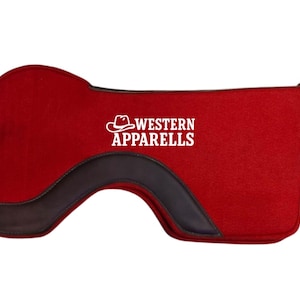 May include: A red Western saddle pad with a dark brown leather accent and the text "WESTERN APPARELLS" in white. The pad is designed with a curved shape and is likely used for horseback riding.