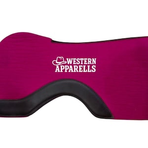 May include: A magenta-colored saddle pad with a black leather accent. The pad features the white text "WESTERN APPARELS" with a cowboy hat logo. The pad is designed for equestrian use and has a contoured shape.