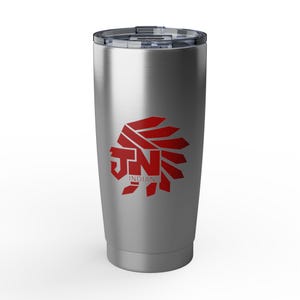 May include: A silver stainless steel tumbler with a clear plastic lid. The front features a red graphic logo of a stylized headdress shape incorporating the letters JN and the word INDIANS printed in a bold, blocky red font on the body.