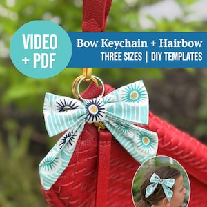 May include: A fabric bow keychain with a light blue and white sunburst pattern attached to a red textured bag. The image includes text reading: VIDEO + PDF, Bow Keychain + Hairbow, THREE SIZES | DIY TEMPLATES, and a circular inset showing the bow.