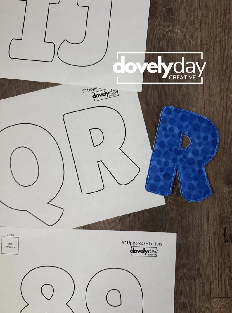 May include: A blue fabric letter R with a polka dot pattern placed next to printed paper templates of uppercase letters and numbers. The templates feature the text 5 inch Uppercase Letters, 1 inch size reference, and the logo dovelyday CREATIVE.