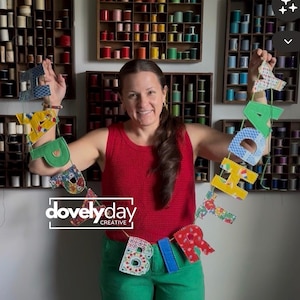May include: A fabric birthday banner featuring individual letters in various colorful patterns and solid colors, strung together on a thin cord. The banner spells out the word birthday with each letter crafted from different textiles and textures.