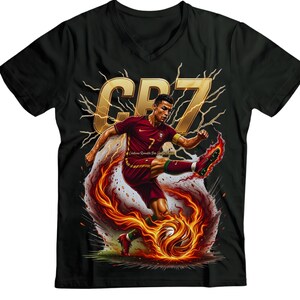 May include: Black V-neck t-shirt featuring a graphic of a soccer player in a maroon uniform kicking a flaming soccer ball. The shirt has the text "CR7" in gold, with lightning bolt accents.