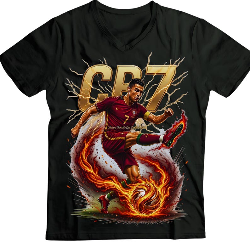 May include: Black V-neck t-shirt featuring a graphic of a soccer player in a maroon uniform kicking a flaming soccer ball. The shirt has the text "CR7" in gold, with lightning bolt accents.