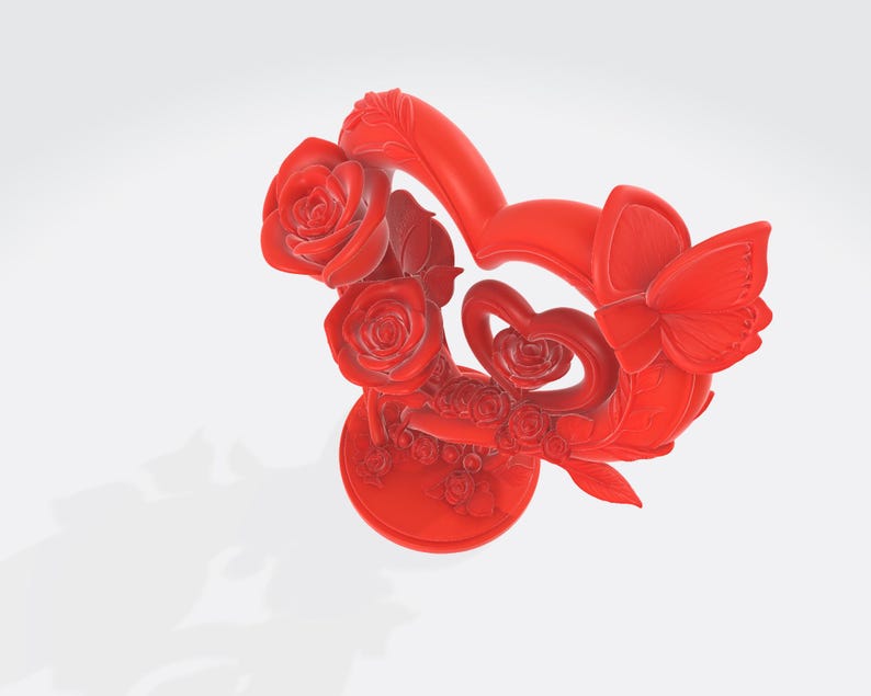 May include: A vibrant red decorative sculpture featuring a heart-shaped design, adorned with roses, a butterfly, and smaller heart accents. The sculpture is set on a round base, showcasing intricate details and a smooth finish.