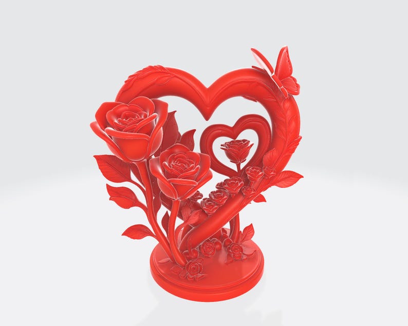 May include: A red decorative sculpture featuring a heart-shaped design with roses and a butterfly. The sculpture has a round base and includes two large roses, smaller roses, and a butterfly on the heart.