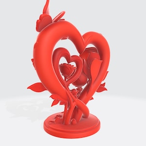 May include: A red sculpture featuring two intertwined hearts, with a rose at the center. The sculpture has a circular base and is adorned with leaves and floral details. The design is a romantic and decorative piece.