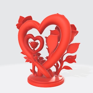 May include: A red heart-shaped sculpture with roses and leaves. The sculpture features a large heart encompassing a smaller heart, with roses and foliage arranged around the edges. The base is round, and the entire piece is a vibrant red.