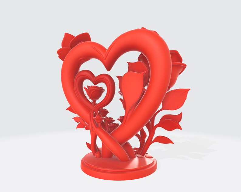 May include: A red heart-shaped sculpture with roses and leaves. The sculpture features a large heart encompassing a smaller heart, with roses and foliage arranged around the edges. The base is round, and the entire piece is a vibrant red.