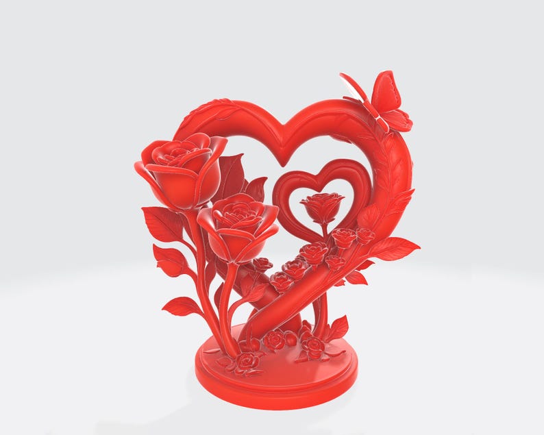 May include: A red decorative sculpture featuring a heart-shaped frame with a smaller heart inside. Roses and leaves are arranged around the heart, and a butterfly sits atop the frame. The sculpture is on a round base.