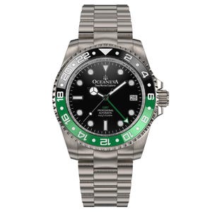 May include: A stainless steel wristwatch with a black dial and a green and black bezel. The watch features the text "OCEANEVA Deep Marine Explorer" and "GMT PROFESSIONAL AUTOMATIC 4101/0/1250". The watch has a date display at the 3 o'clock position.