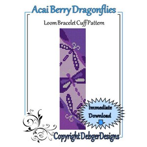 May include: A loom bracelet cuff pattern featuring a purple and white design with dragonflies. The pattern is called "Acai Berry Dragonflies" and includes the text "Copyright DebgerDesigns".
