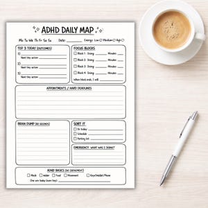 May include: ADHD Daily Map printed on white paper with sections for daily planning, including "Top 3 Today," "Focus Blocks," and "Brain Dump." A cup of coffee and a pen are on the wooden surface.