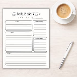 May include: A white daily planner with the words "DAILY PLANNER" at the top, featuring sections for goals, tasks, notes, and appointments. A cup of coffee and a pen are next to the planner.