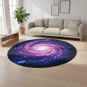 May include: A round rug featuring a vibrant galaxy design. The rug showcases a swirling pattern of purple, pink, and blue hues, with a bright white center. The rug is placed on a light-colored wooden floor, complementing the room's neutral tones.