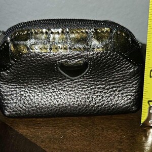 May include: A white ceramic mug with a black handle and the text "But First, Coffee" in a black, handwritten-style font. The mug is on a white surface.