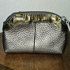 May include: A set of three ceramic canisters with lids. The canisters are white with a blue floral pattern. The largest canister is 8 inches tall, the medium is 7 inches, and the smallest is 6 inches.