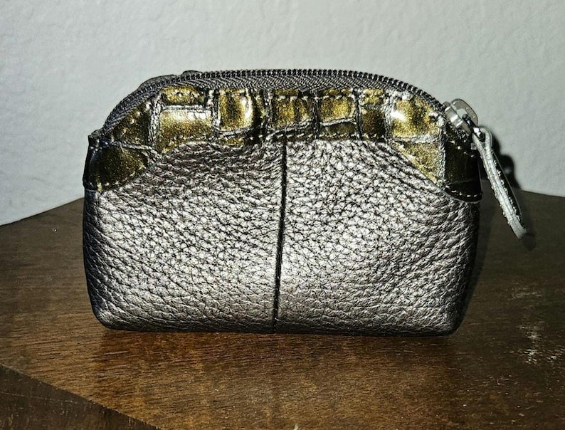 May include: A set of three ceramic canisters with lids. The canisters are white with a blue floral pattern. The largest canister is 8 inches tall, the medium is 7 inches, and the smallest is 6 inches.