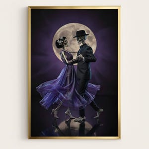 May include: A framed art print shows two skeletons dancing in front of a full moon. The skeleton in a suit and hat holds the hand of the skeleton in a purple dress. The background is a dark purple with light rays emanating from behind the moon.