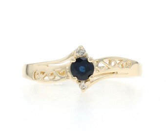 Geelgouden bypass-ring blauwe saffier diamant - 10k rond 0,22 ct