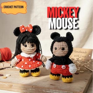 May include: Two crocheted Mickey Mouse dolls. One doll is Minnie Mouse, wearing a red dress with white polka dots and a red bow. The other doll is Mickey Mouse, wearing red shorts and black clothing. The dolls are handmade.