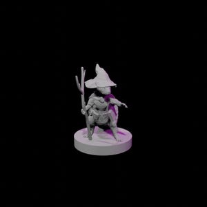 May include: A light grey miniature figurine of a turtle character wearing a wide-brimmed pointed hat and a cape. The figure stands on a circular base, holding a tall, branch-like staff in one hand, with a belt and pouch visible around its waist.