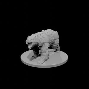 May include: A gray, 3D-printed bear figurine, posed in a menacing stance. The bear is wearing armor on its shoulders, legs, and back. The figurine is on a circular base, set against a black background.
