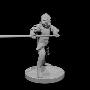 May include: A gray 3D-printed figurine of a humanoid ape warrior in armor, holding a spear. The figure is standing on a circular base against a black background. The armor includes a helmet, shoulder pads, and leg guards.