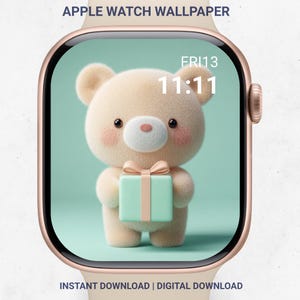 May include: Apple Watch wallpaper featuring a cute beige teddy bear holding a mint green gift box with a pink ribbon. The watch face displays the time 11:11 and the date Fri 13. The text "APPLE WATCH WALLPAPER" and "INSTANT DOWNLOAD | DIGITAL DOWNLOAD" are also visible.