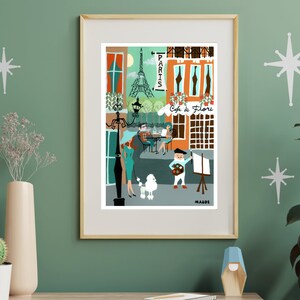 May include: A framed art print depicting a Parisian street scene with the Eiffel Tower, a cafe, and figures. The artwork features a palette of orange, teal, and brown, with the word "Paris" and "Cafe de Flore" visible.