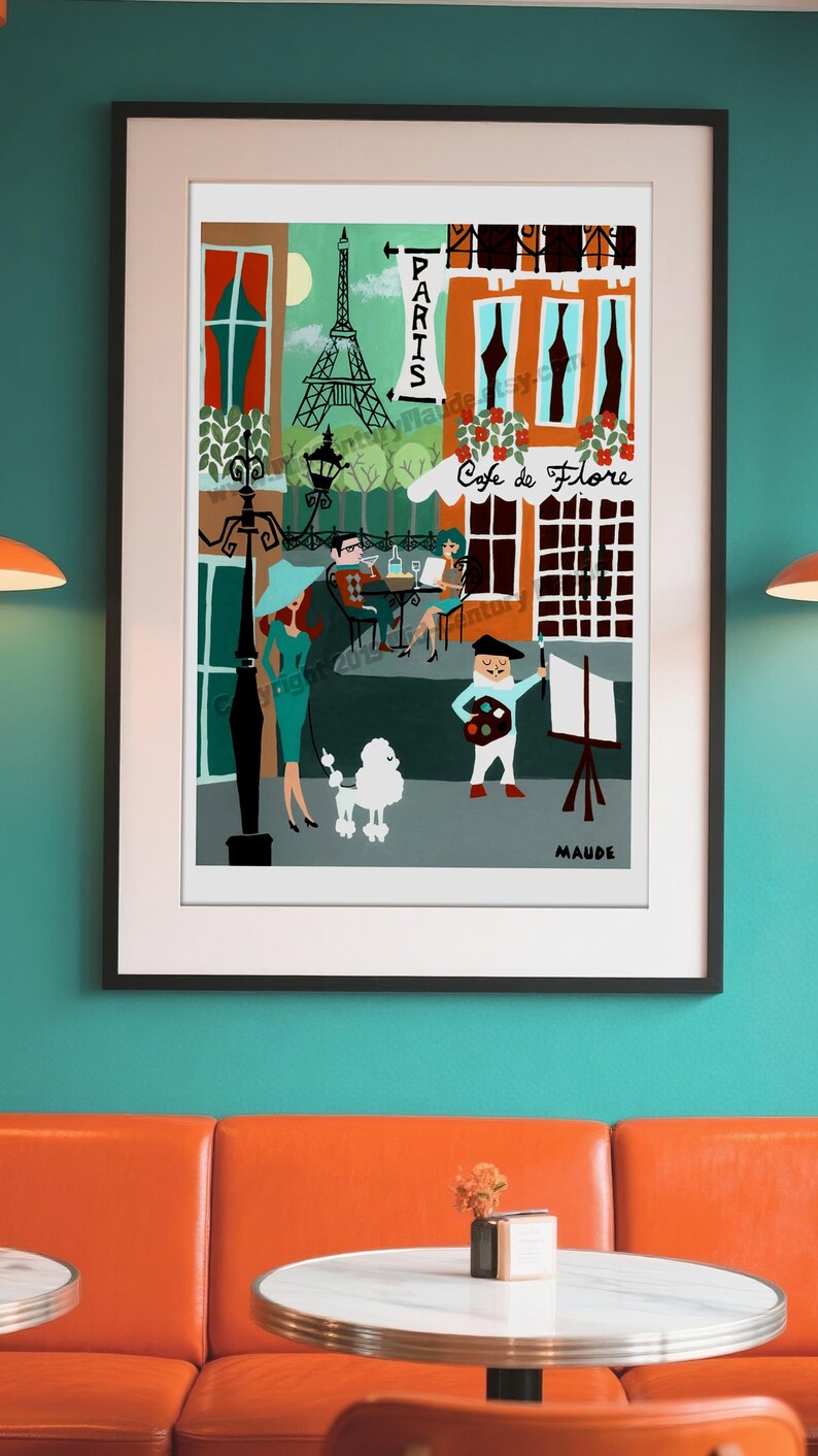 A large format framed wall art print of Paris by Mid-Century Maude. Features a French poodle, the Eiffel tower, and a cafe.  It is framed and mounted on the wall of a retro coffee shop