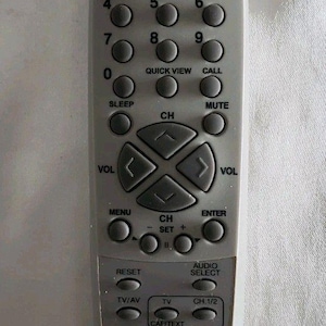 May include: A gray TV remote control with numerous buttons, including power, channel, volume, and number keys. The remote also features buttons for sleep, mute, and closed captioning. The text "CCD CLOSED CAPTION DECODER" is printed on the remote.