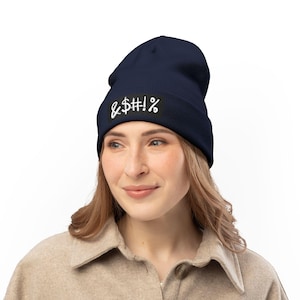 May include: Navy blue beanie with white text reading "& $#!%". The beanie is made of a soft material and is designed to be worn on the head. A casual accessory for cold weather.