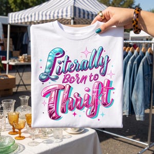 May include: A white t-shirt featuring the text Literally Born to Thrift in a stylized, glossy font. The word Literally is in a gradient of blue and purple, while Born to and Thrift are in shades of pink and purple, accented by small star shapes.