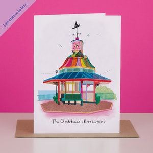 May include: A colourful illustration of a clock tower with a clock face and a weathervane on top. The clock tower is surrounded by a fence and has a bench in front of it. The text "The Clocktower, Broadstairs." is written below the illustration.