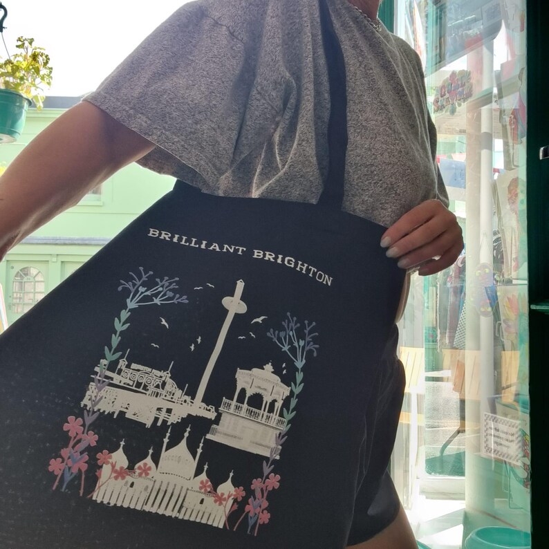 May include: Black tote bag with a white graphic of the Brighton Pier and the text "BRILLIANT BRIGHTON" printed on the front.