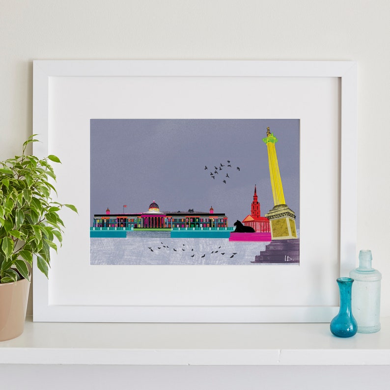 May include: A colorful illustration of a cityscape with a tall column, a red building, and a large building with a dome. The illustration is framed in a white frame and set against a white wall.