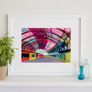 May include: A colourful illustration of a train station with a train platform and a train. The roof of the station is made of colourful geometric shapes.