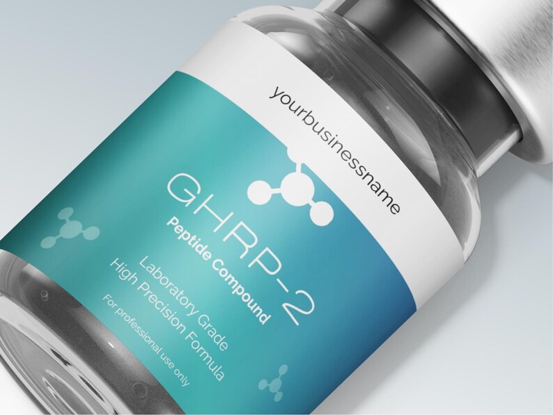 May include: A close-up of a clear glass vial with a white and teal label. The label features the text "GHRP-2 Peptide Compound" and "Laboratory Grade High Precision Formula". The vial is labeled "yourbusinessname" and is for professional use only.