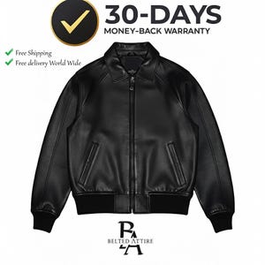 May include: A black leather bomber jacket with a zip-up front, collar, and two front pockets. The jacket has ribbed cuffs and hem. The image includes the text "30-DAYS MONEY-BACK WARRANTY" and the brand name "BELTED ATTIRE".